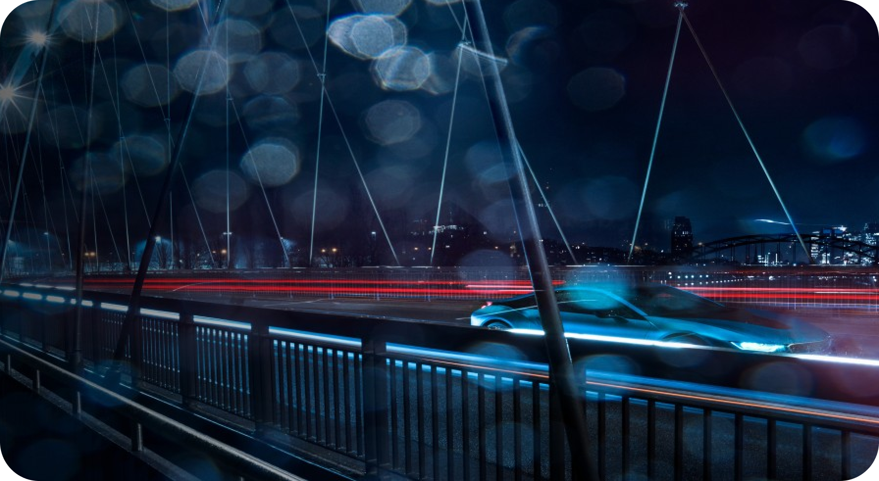 Modern electric car speeding across a city bridge at night with dynamic light trails and urban skyline in the background.