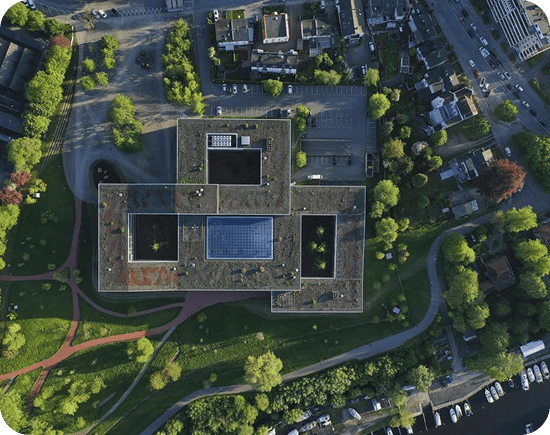 Aerial view of Dräger’s headquarters with a sustainable green roof, located in a landscaped urban area. Aerial view of Dräger’s headquarters with a sustainable green roof, located in a landscaped urban area.