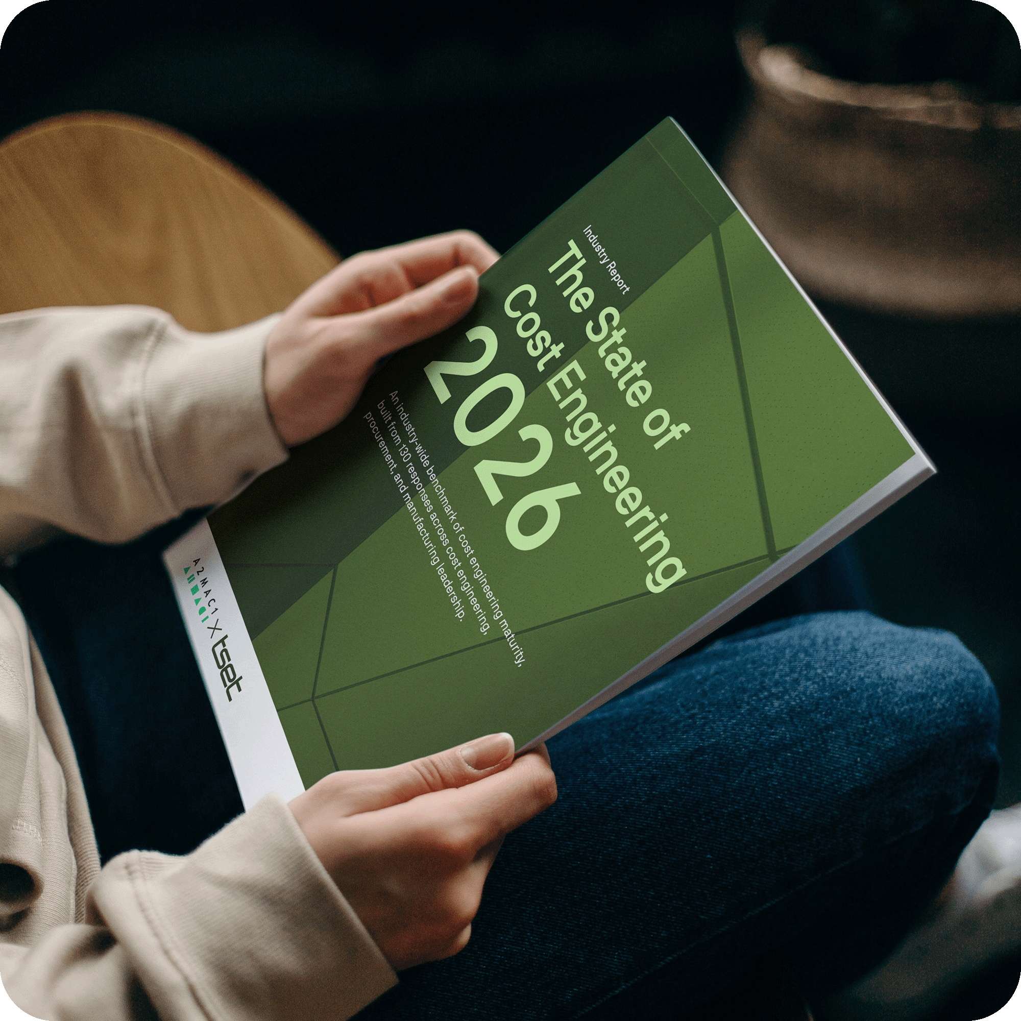 A man holding a printed version of The State of Cost Engineering report A man holding a printed version of The State of Cost Engineering report