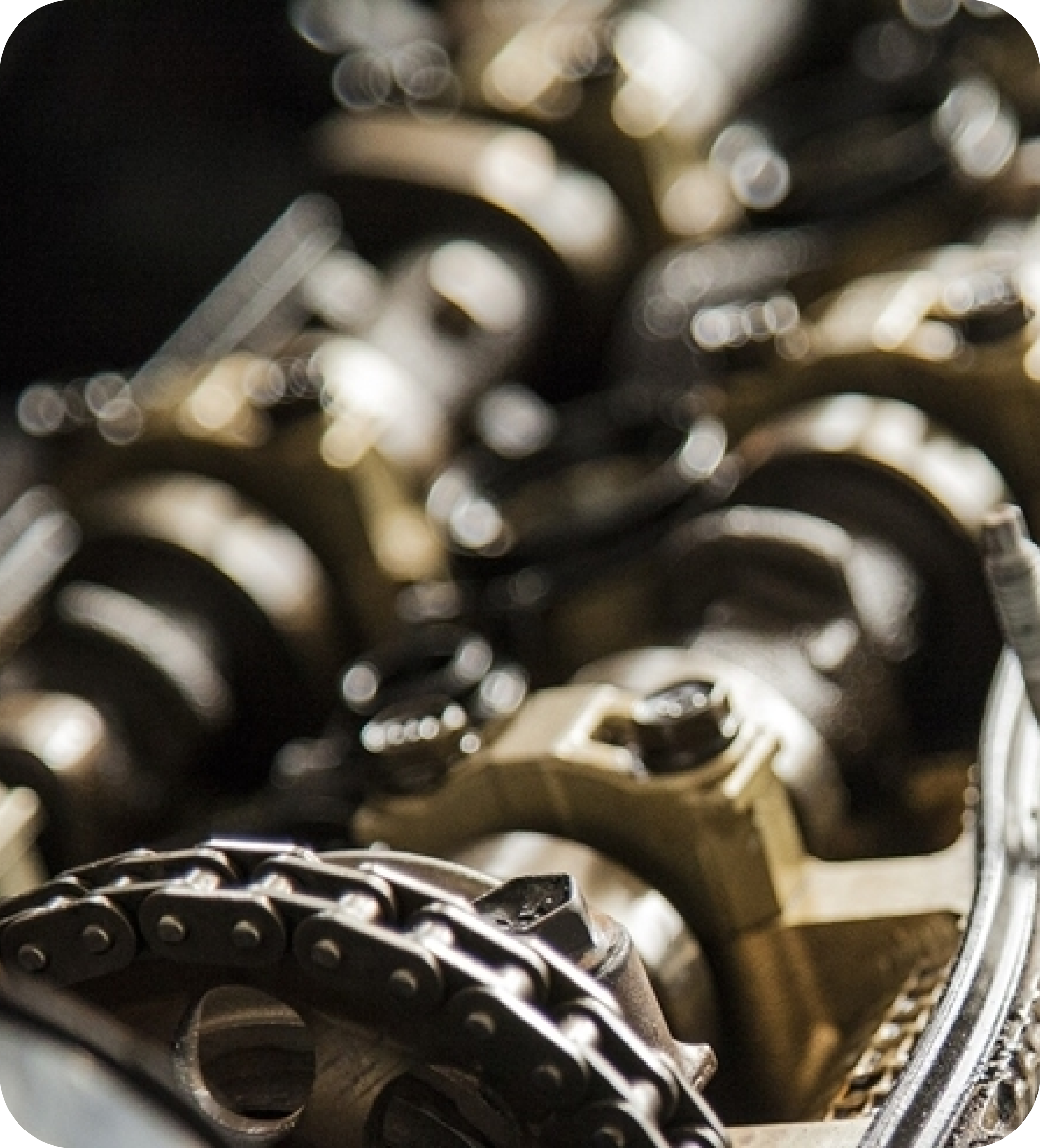 Detailed macro shot of mechanical engine parts with chain drive, symbolizing precision engineering and automotive manufacturing.
