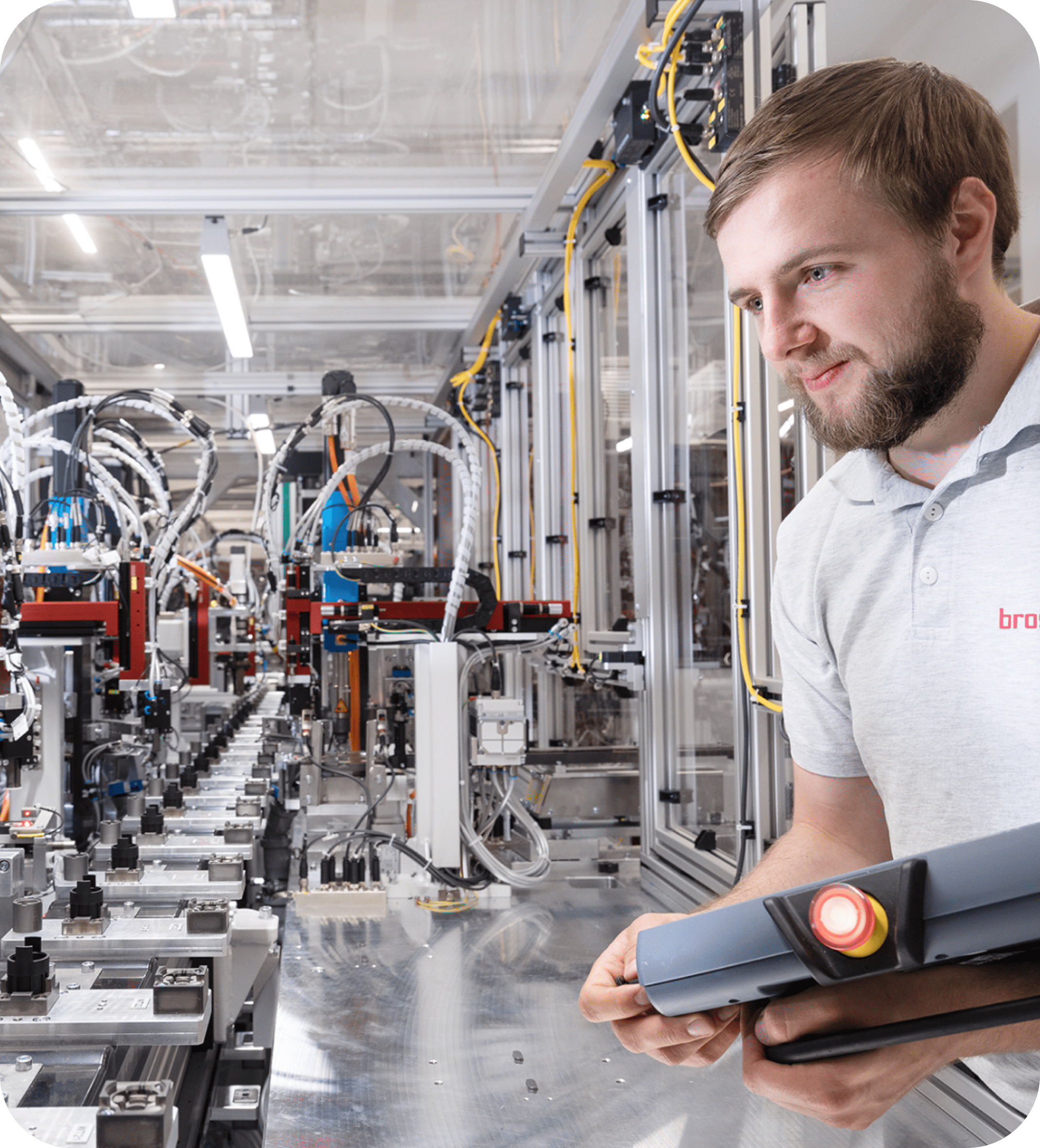 Engineer at Brose managing a high-tech automotive assembly line, showcasing digital control and automation in manufacturing processes.