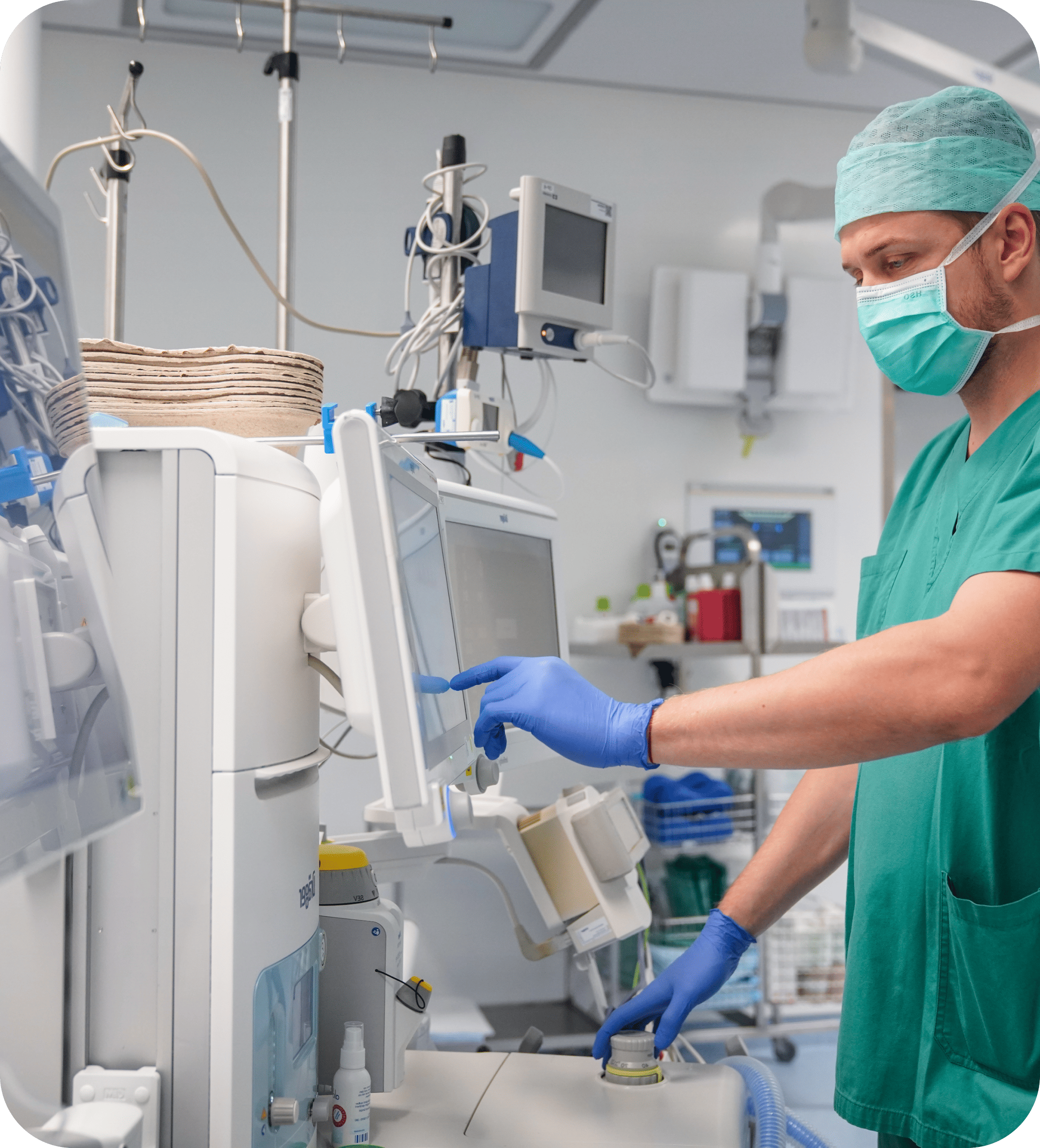 Healthcare worker using Dräger medical equipment in a clinical setting, highlighting precision technology in patient care environments.