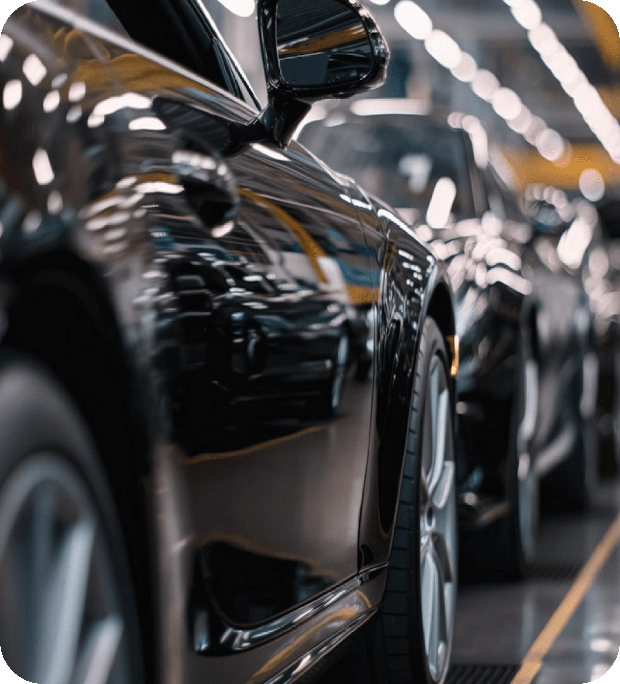 Modern passenger cars aligned in an automotive assembly plant