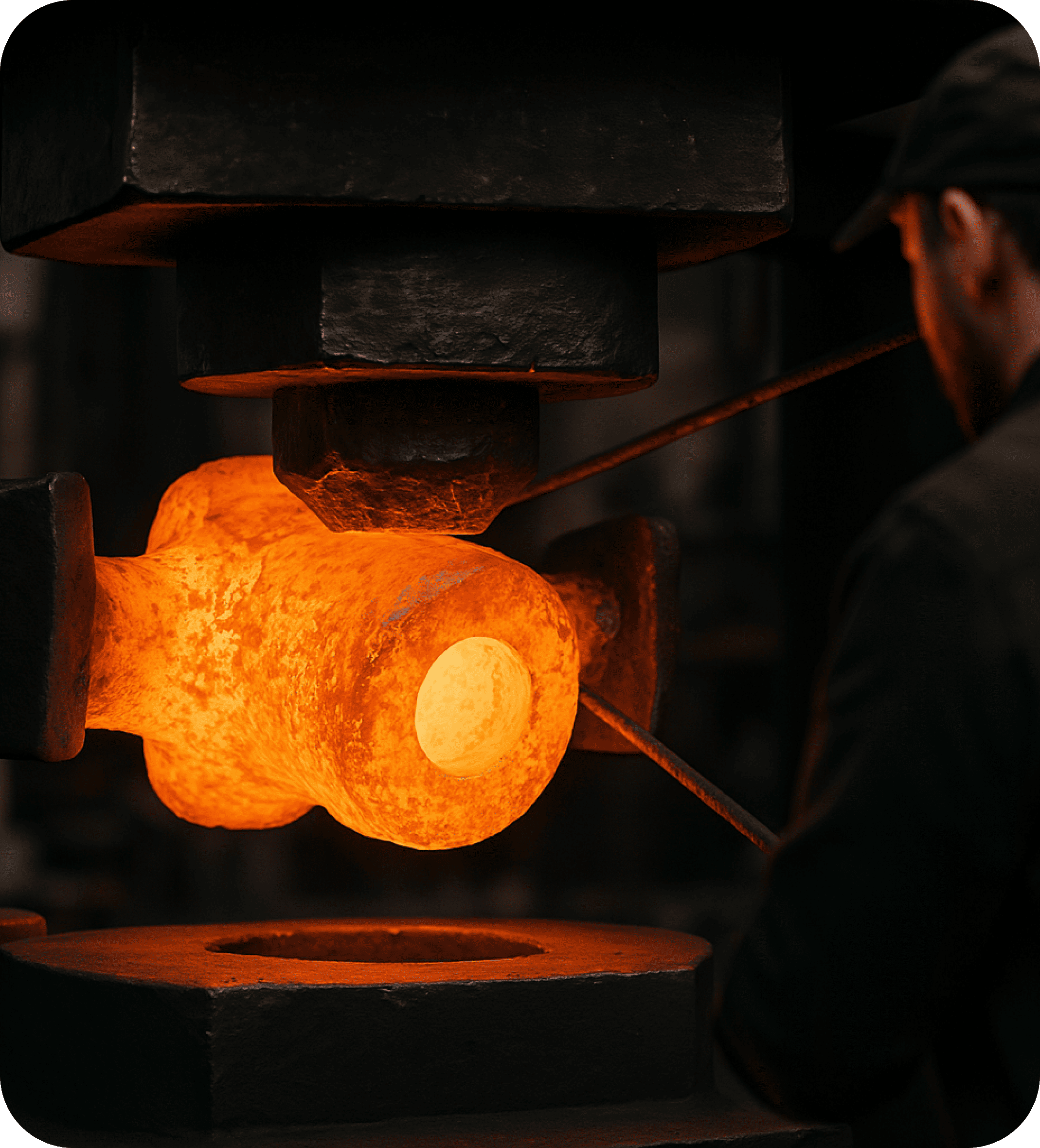 Close-up of a hot metal workpiece being shaped under a forging press, glowing orange from high heat, with a worker overseeing the process.