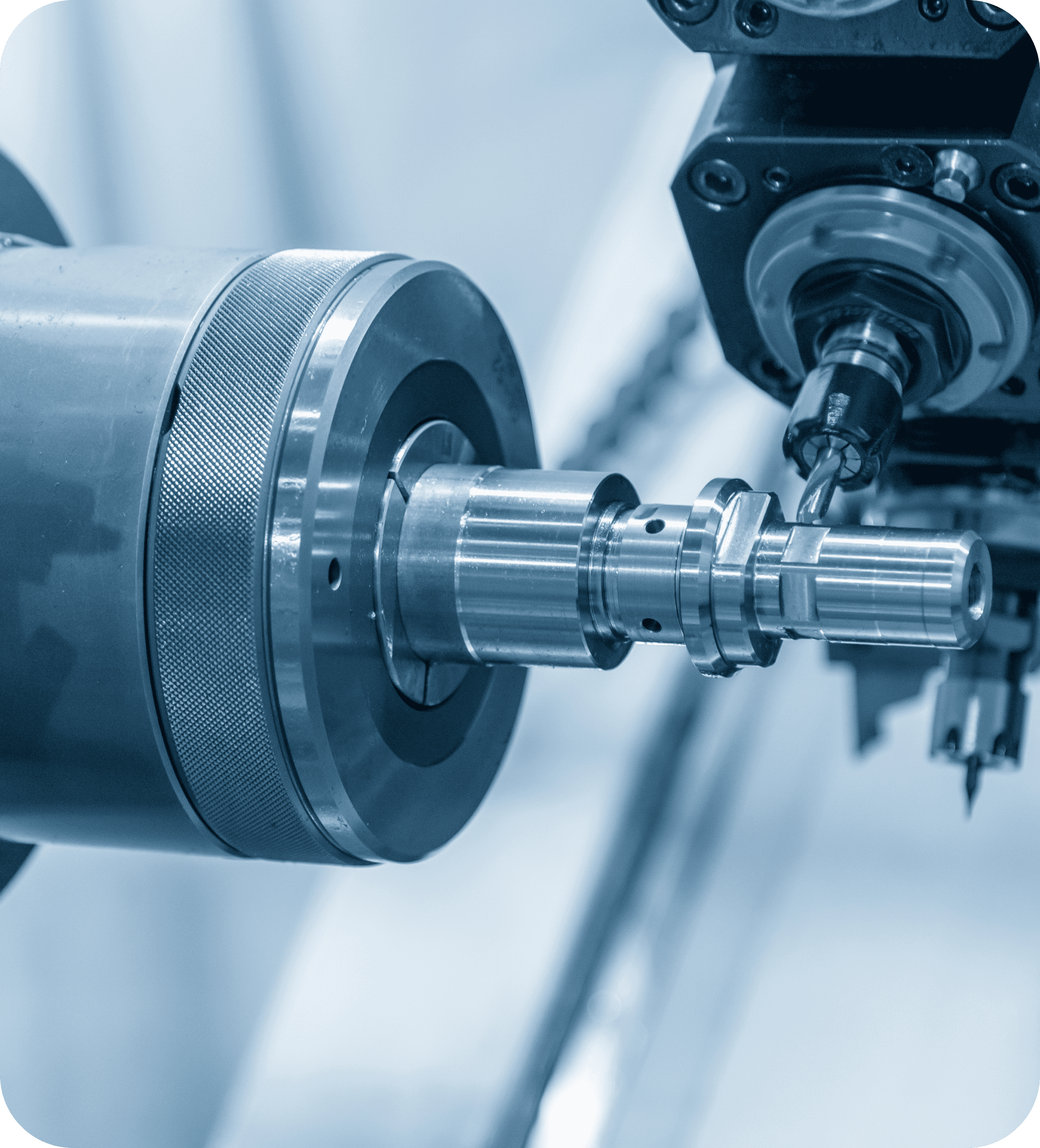 Close-up of a CNC machine drilling into a metal cylinder, emitting a precise, industrial tone. The machinery is highlighted in a cool, blue tint.