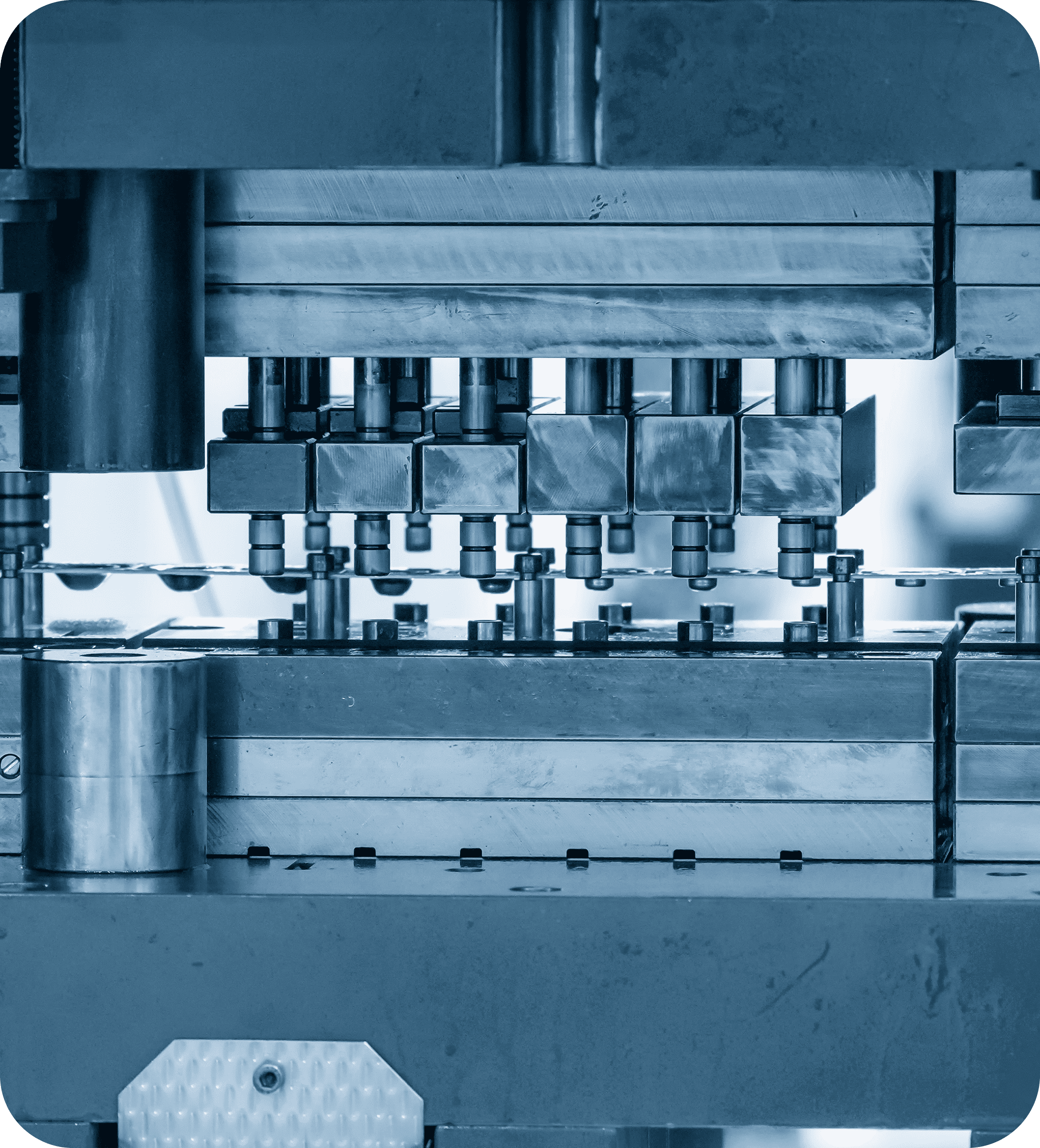 Close-up of an industrial machine with multiple metal rods and components. The blue-toned image conveys precision and engineering technology.