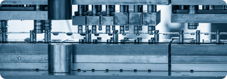 Close-up of an industrial machine with multiple metal rods and components. The blue-toned image conveys precision and engineering technology.