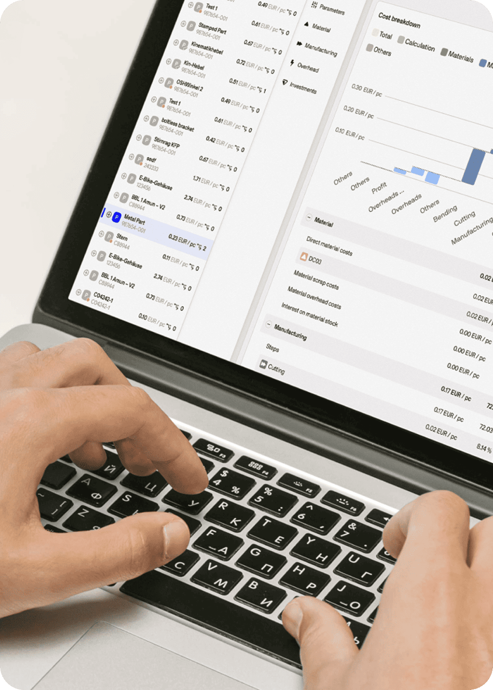 A man using a cost engineering software tset on a macbook